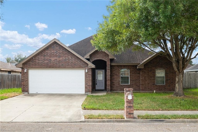 view of front facade with a garage and a front lawn