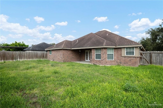 back of house featuring a yard