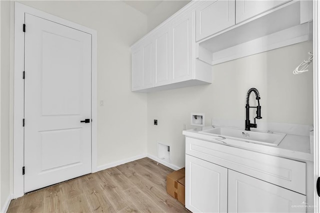 washroom with sink, cabinets, light hardwood / wood-style flooring, electric dryer hookup, and washer hookup