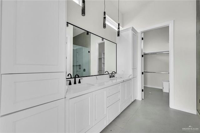 bathroom with a shower with door, vanity, and a high ceiling