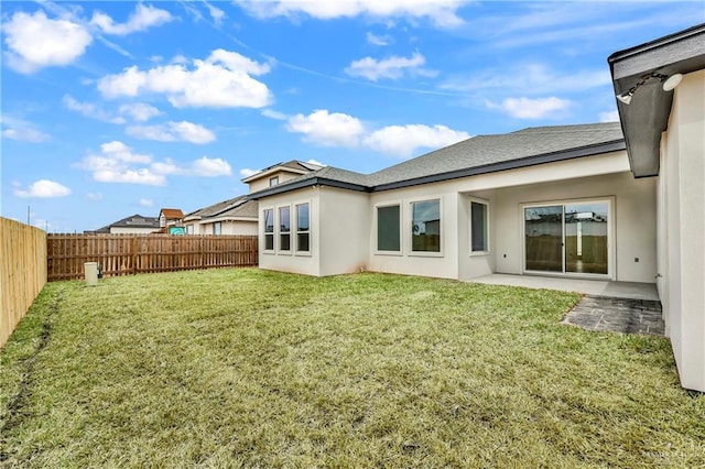 back of property featuring a yard and a patio