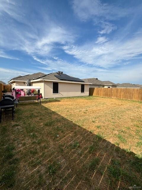 back of house featuring a lawn