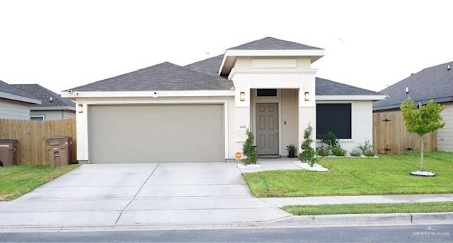 view of front of home featuring a front lawn and a garage