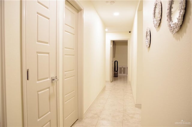 hall with light tile patterned floors