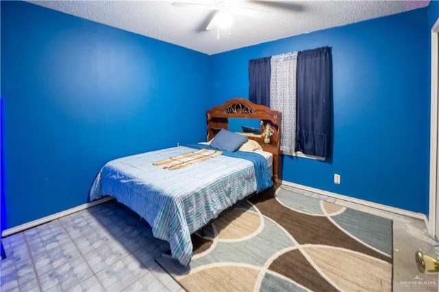 bedroom with ceiling fan and a textured ceiling