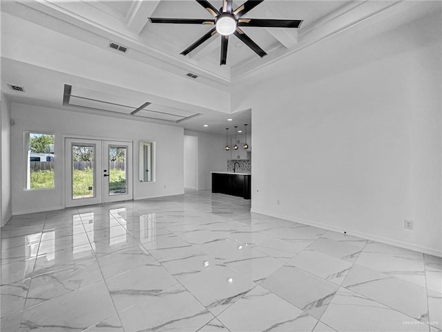 unfurnished living room with beamed ceiling, french doors, a towering ceiling, and ceiling fan