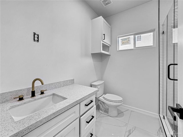 bathroom with vanity, an enclosed shower, and toilet