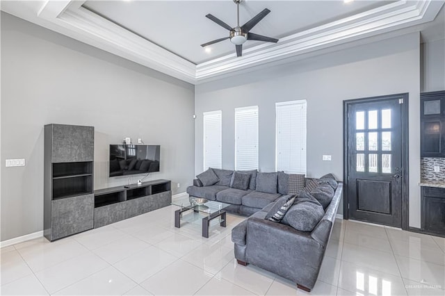 3527 Oak Preserve St, Weslaco, TX 78599 - living area featuring light tile patterned flooring, a raised ceiling, a ceiling fan, and baseboards