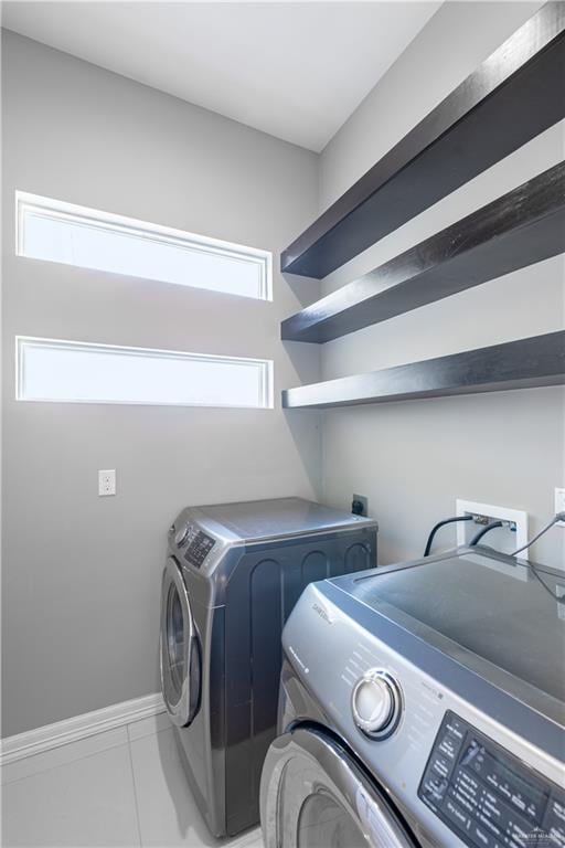 3527 Oak Preserve St, Weslaco, TX 78599 - clothes washing area with washer and clothes dryer, baseboards, and laundry area