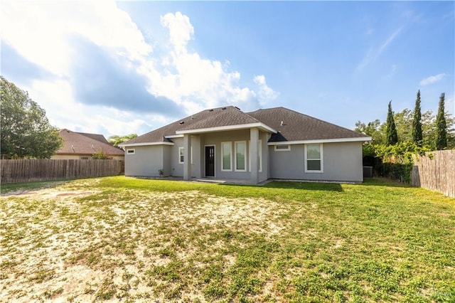 3527 Oak Preserve St, Weslaco, TX 78599 - rear view of property featuring a lawn, a fenced backyard, and stucco siding
