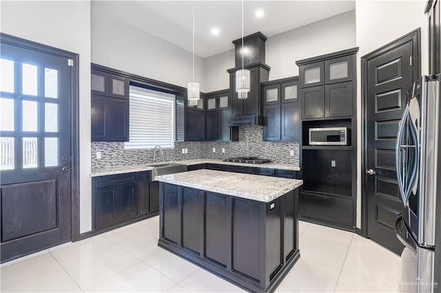 3527 Oak Preserve St, Weslaco, TX 78599 - kitchen with backsplash, a sink, a kitchen island, hanging light fixtures, and appliances with stainless steel finishes