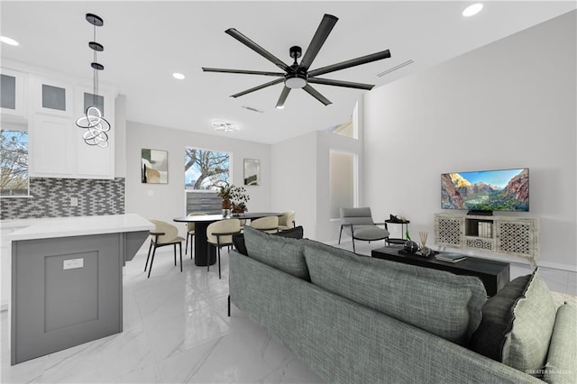 living room with a wealth of natural light and ceiling fan