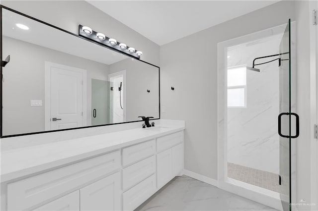 bathroom with an enclosed shower and vanity