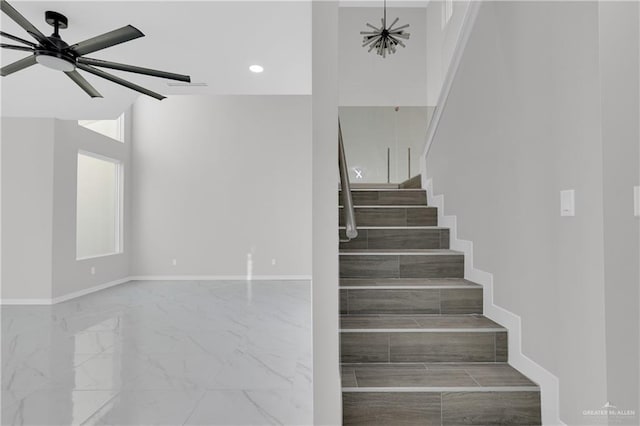 stairway with ceiling fan with notable chandelier