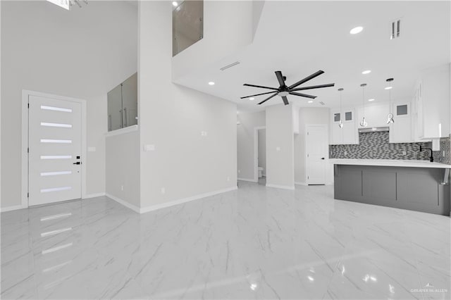 unfurnished living room featuring ceiling fan