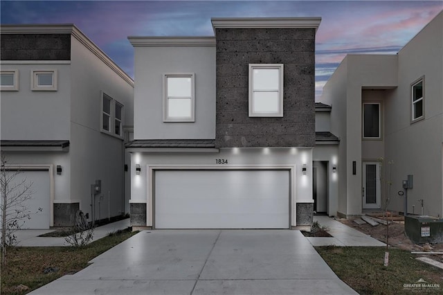 view of front of property featuring a garage and central AC unit