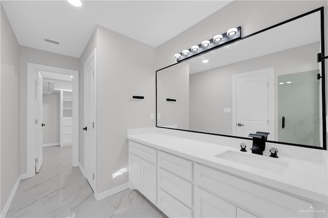 bathroom featuring vanity and a shower with door