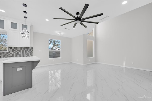 unfurnished living room featuring ceiling fan