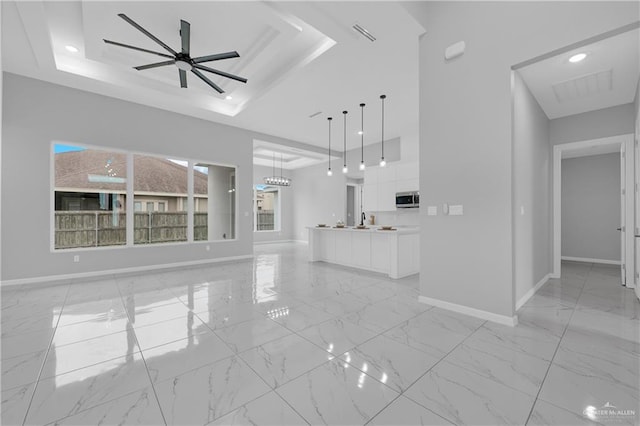 503 Purple Bugambilia, Pharr, TX 78577 - unfurnished living room featuring a tray ceiling, baseboards, light marble finish flooring, ceiling fan, and recessed lighting