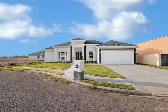 503 Purple Bugambilia, Pharr, TX 78577 - prairie-style home featuring an attached garage, driveway, stucco siding, and a front lawn