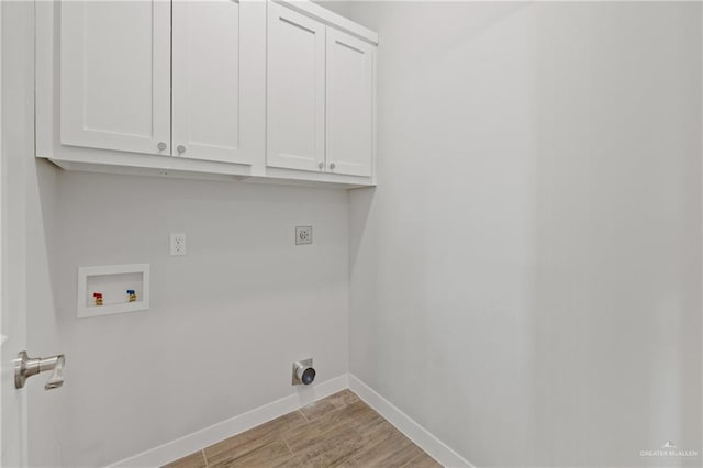 2214 N Gaytan St, Edinburg, TX 78542 - washroom featuring hookup for an electric dryer, cabinet space, hookup for a washing machine, baseboards, and wood finished floors