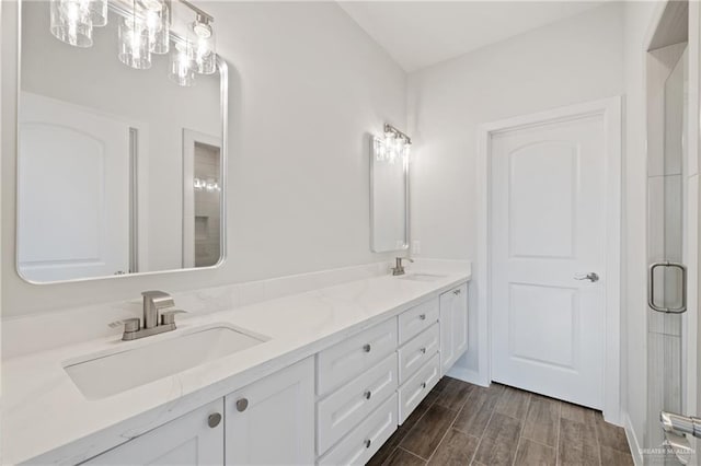 2214 N Gaytan St, Edinburg, TX 78542 - bathroom with double vanity, wood finished floors, and a shower with shower door