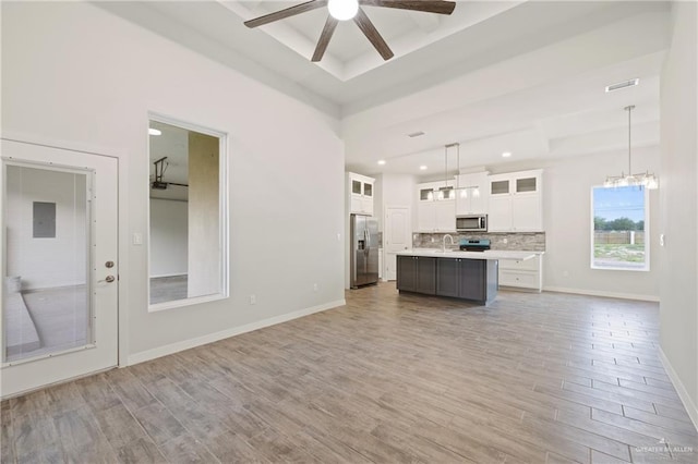 2214 N Gaytan St, Edinburg, TX 78542 - kitchen featuring appliances with stainless steel finishes, ceiling fan, light countertops, open floor plan, and light wood-style flooring