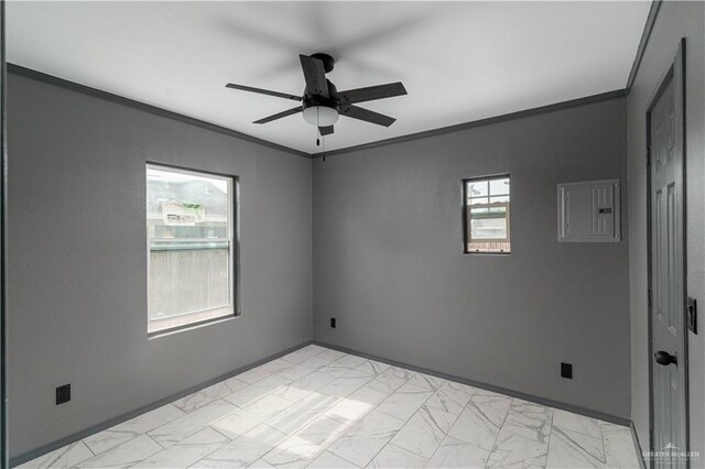 unfurnished room featuring electric panel, a wealth of natural light, crown molding, and ceiling fan