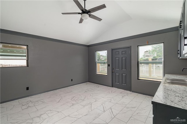 foyer with plenty of natural light, ceiling fan, lofted ceiling, and sink