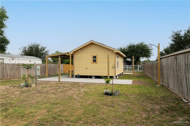 rear view of property with a patio area and a yard