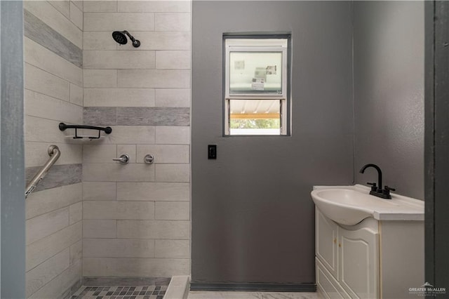 bathroom featuring vanity and tiled shower