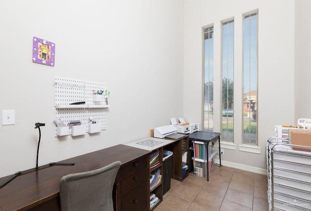 office area featuring light tile patterned flooring and baseboards
