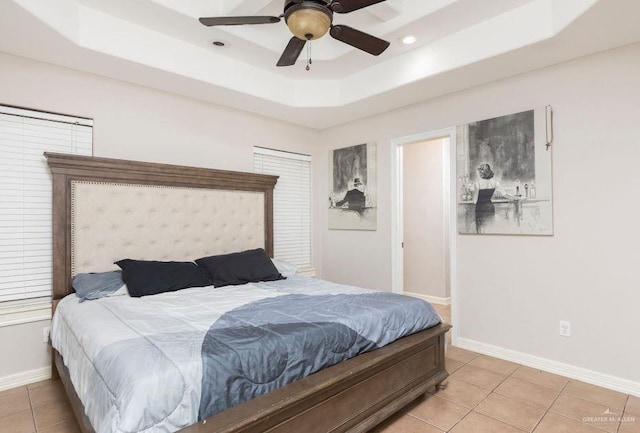 bedroom featuring a ceiling fan, light tile patterned floors, a tray ceiling, baseboards, and recessed lighting
