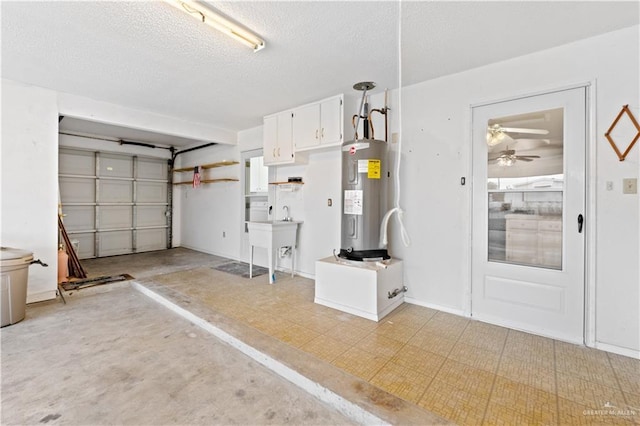 garage with electric water heater, sink, and ceiling fan