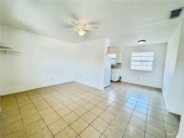 tiled empty room with ceiling fan