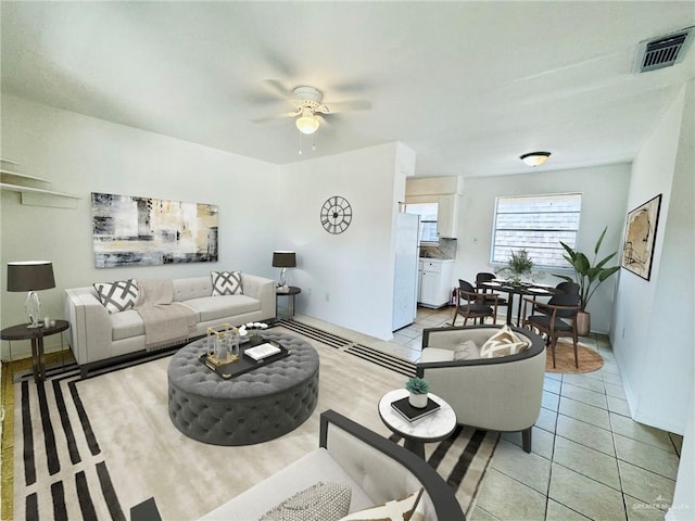 tiled living room with ceiling fan