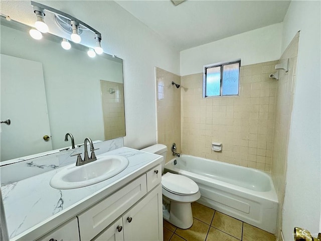 full bathroom featuring tile patterned floors, vanity, tiled shower / bath combo, and toilet