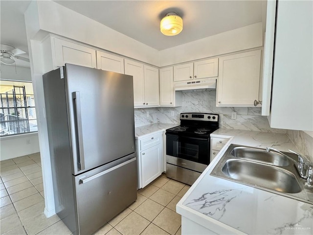 kitchen with appliances with stainless steel finishes, backsplash, ceiling fan, sink, and white cabinets