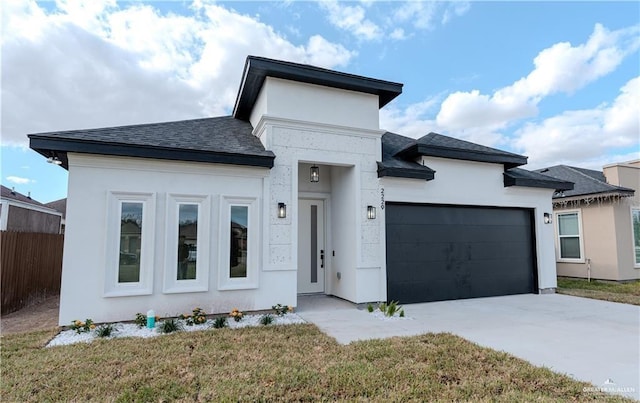 view of front of home featuring driveway, an attached garage, fence, and stucco siding