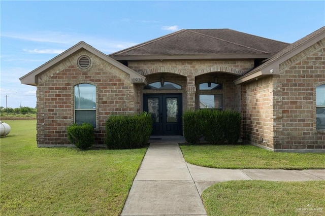 doorway to property with a yard