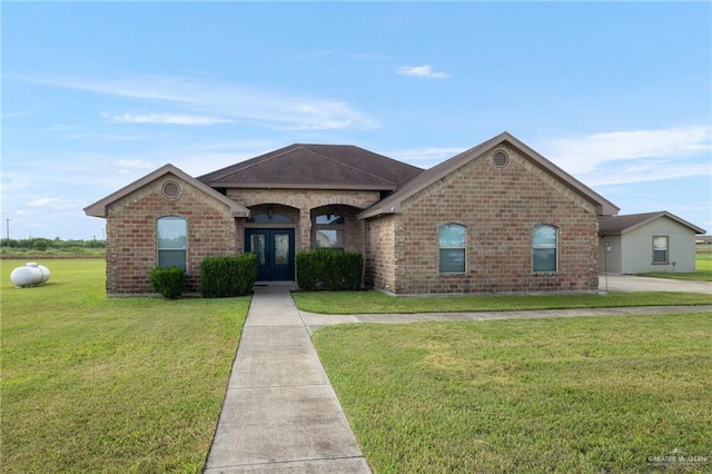 ranch-style house featuring a front yard and french doors