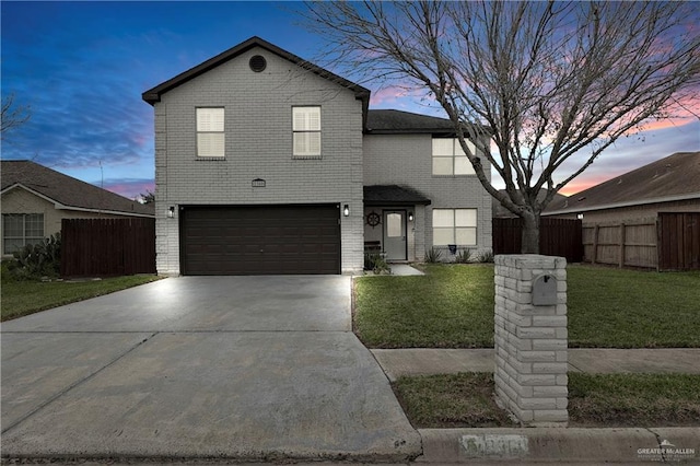 front of property with a yard and a garage