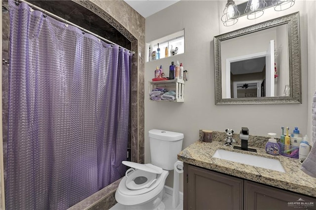 bathroom featuring a shower with curtain, vanity, and toilet