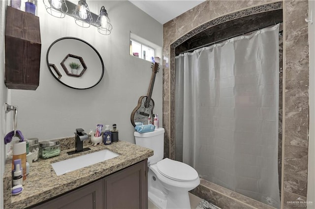 bathroom featuring vanity, curtained shower, and toilet