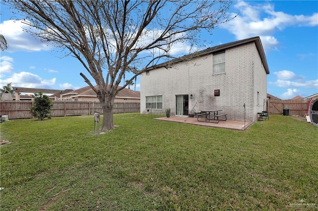 back of property featuring a lawn and a patio area