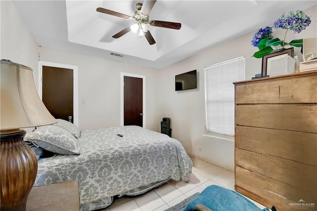 tiled bedroom featuring ceiling fan