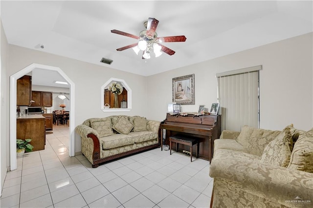 tiled living room with ceiling fan