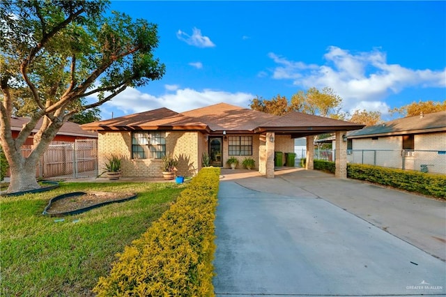 prairie-style home with a front lawn and a carport