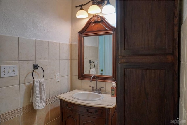 bathroom with tile walls and vanity