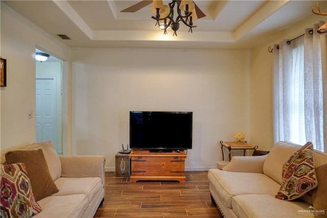 living room featuring a raised ceiling